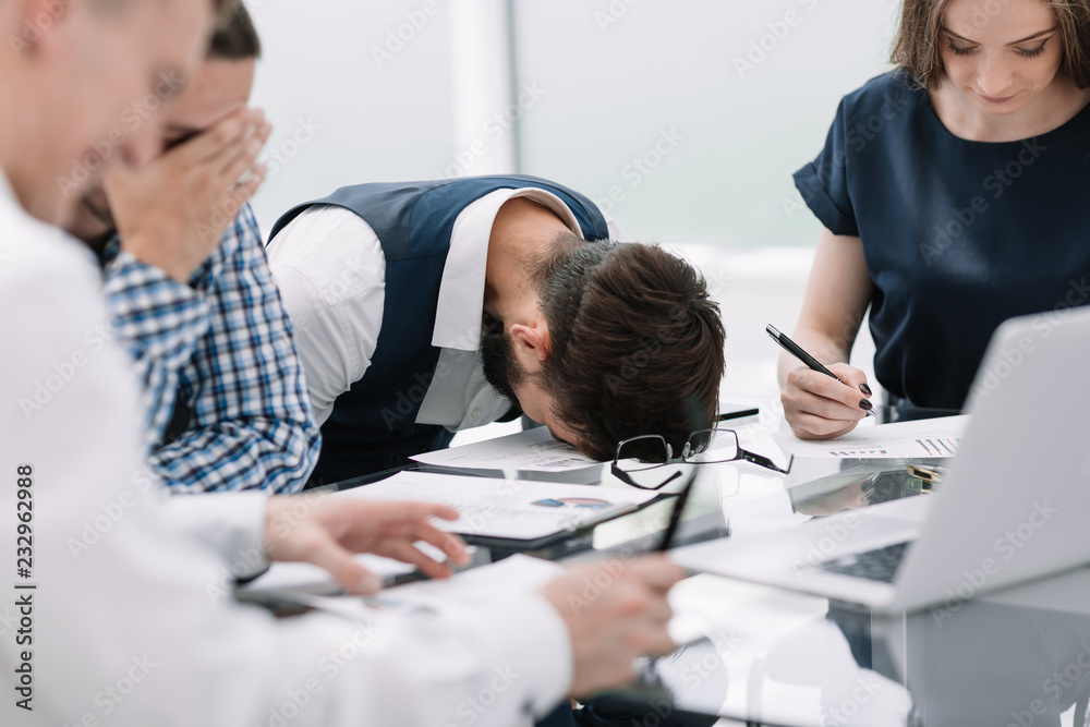 tired employee at a business meeting in the office
