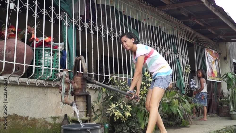 beautiful lady pumps out water from a deep well hand held water pump beautiful lady pumps out water from a deep well hand held water pump