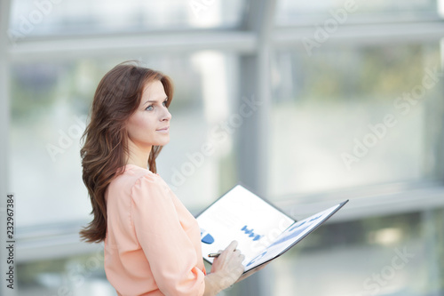 Free Download rear view.a young business woman holds a folder with financial documents - GFXLoad