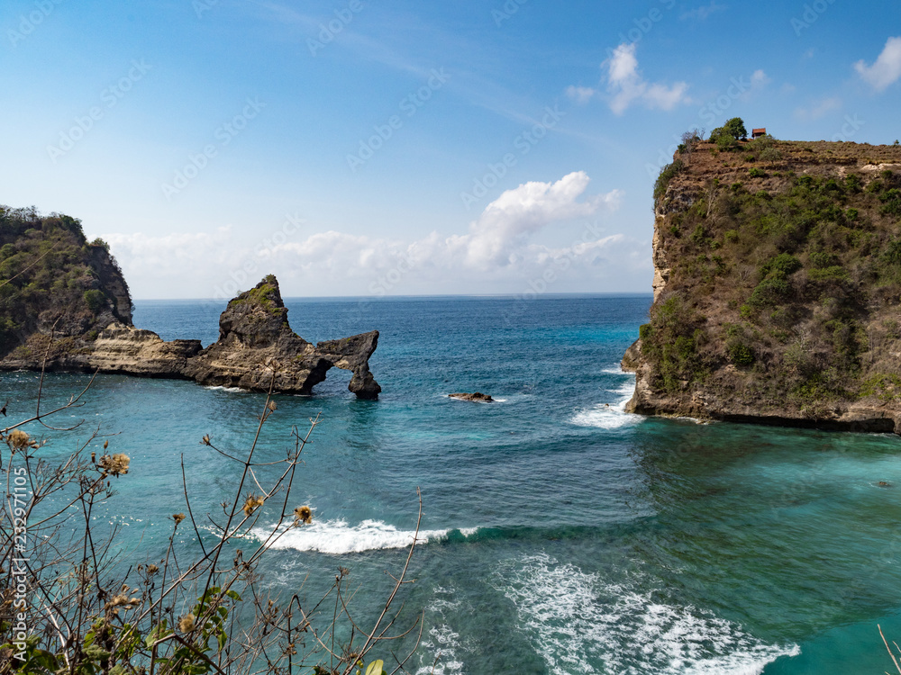 View of tropical beach, sea rocks and turquoise ocean, blue sky. Atuh beach, Nusa Penida island, is located to the southeast of the island of Bali, Indonesia. Travel concept. Indonesia, October, 2018