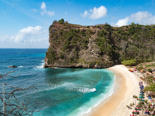 View of tropical beach, sea rocks and turquoise ocean, blue sky. Atuh beach, Nusa Penida island, is located to the southeast of the island of Bali, Indonesia. Travel concept. Indonesia, October, 2018