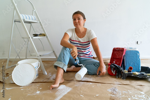 women in the room with white wall and painting equipment