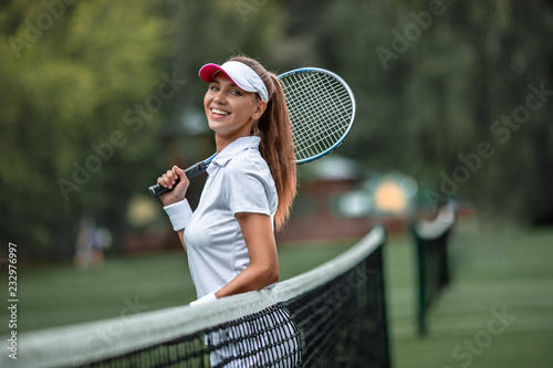 Smiling girl with a racket © AboutLife