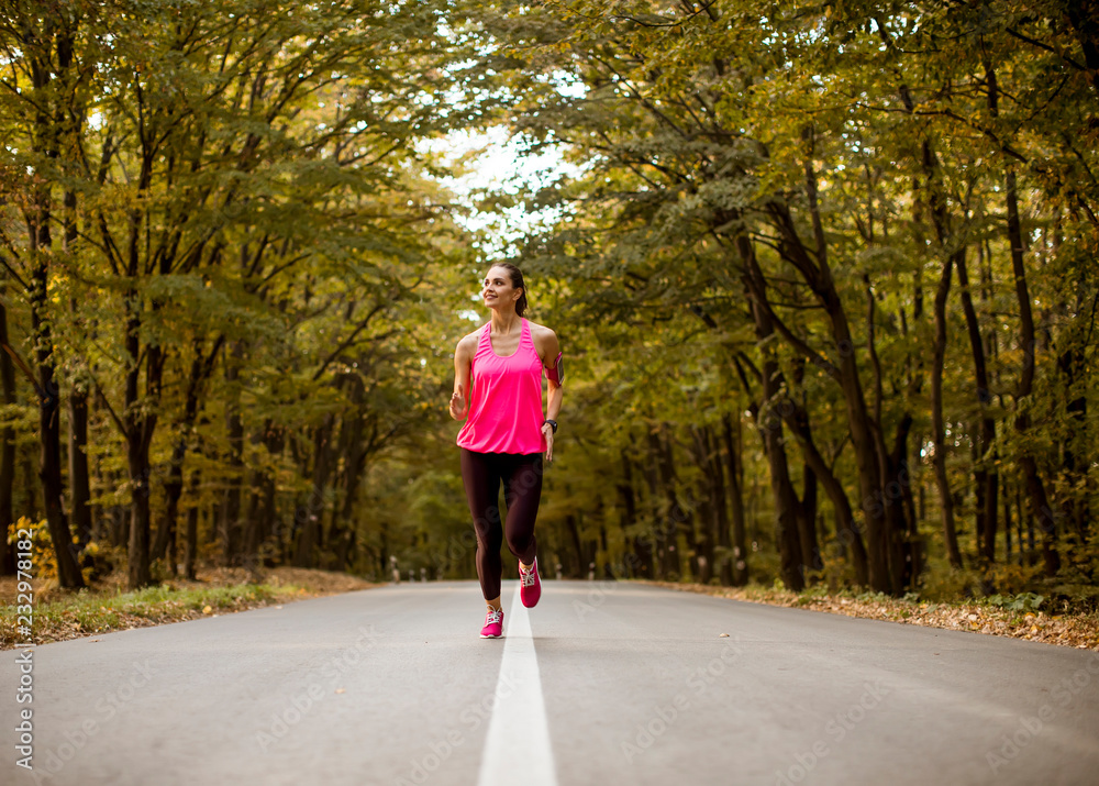 Young fitness woman running at forest trail Young fitness woman running at forest trail