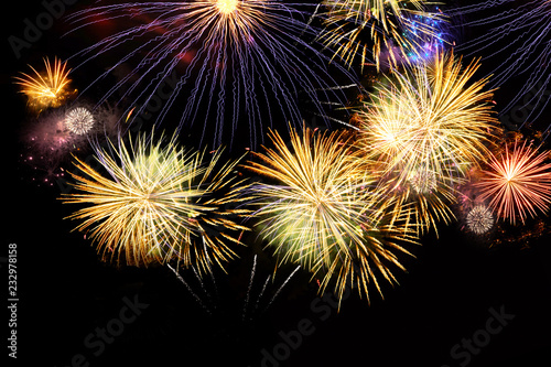 Fireworks colorful explosions on black, festive christmas background