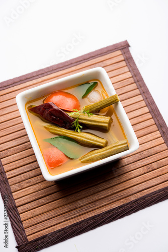 Drumstick Curry or Shevga sheng bhaji or south indian Sambar, served in a bowl over moody background. Selective focus photo