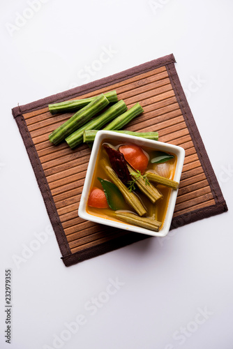 Drumstick Curry or Shevga sheng bhaji or south indian Sambar, served in a bowl over moody background. Selective focus photo