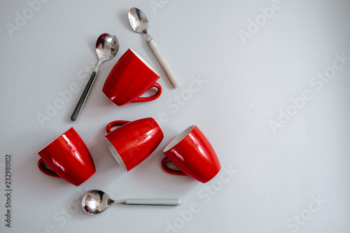 Christmas tree made of red coffee cups and spoons. Creative flat lay, minimalism concept