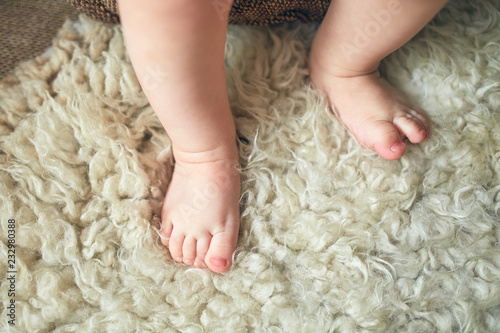 baby feet on a wool rug