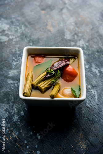 Drumstick Curry or Shevga sheng bhaji or south indian Sambar, served in a bowl over moody background. Selective focus photo