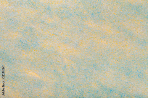 Lght yellow and blue background of felt fabric. Texture of woolen textile