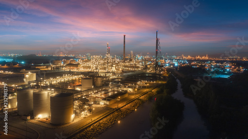 Oil refinery factory with beautiful sky at dusk for energy or gas industry or transportation background.