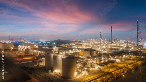 Oil refinery factory with beautiful sky at dusk for energy or gas industry or transportation background.