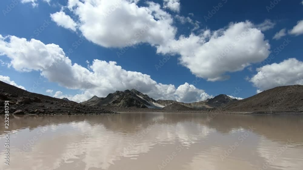 Timelapse gorge cliffs and mountain lake with moving sky shadows and clouds. North Caucasus. Russia Timelapse gorge cliffs and mountain lake with moving sky shadows and clouds. North Caucasus. Russia
