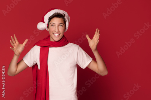 Happy teenager boy in Santa Claus hat.