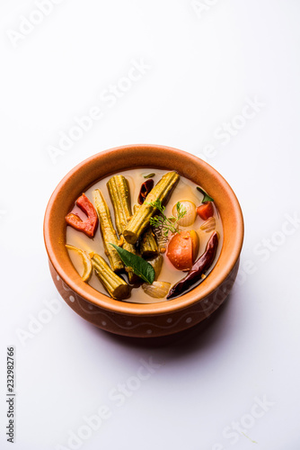 Drumstick Curry or Shevga sheng bhaji or south indian Sambar, served in a bowl over moody background. Selective focus photo