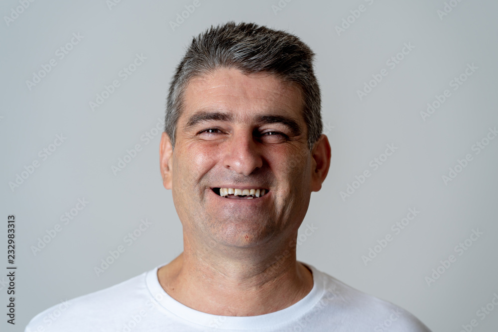 Close up portrait of a smiling and laughing mature man in happy face human emotions and expressions Close up portrait of a smiling and laughing mature man in happy face human emotions and expressions