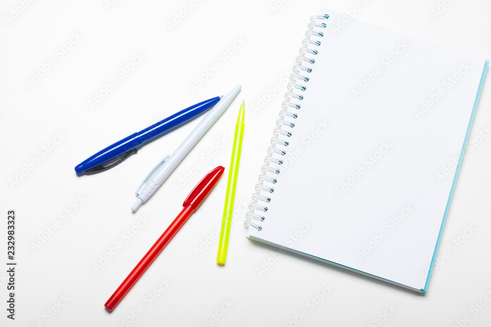 notepad notebook and ball pont pen isolated on white background notepad notebook and ball pont pen isolated on white background