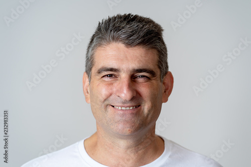 Close up portrait of a smiling and laughing mature man in happy face human emotions and expressions