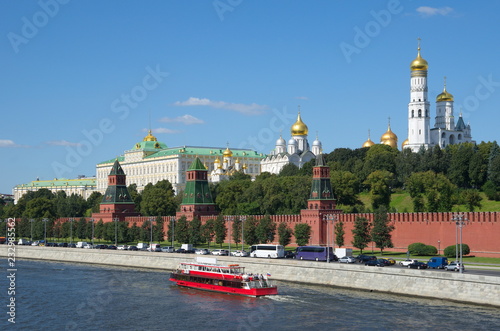 Summer view of the Moscow Kremlin, the Kremlin embankment and a pleasure boat, Russia