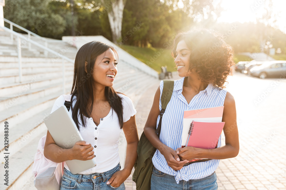 Two happy young students girls standing outdoors Two happy young students girls standing outdoors
