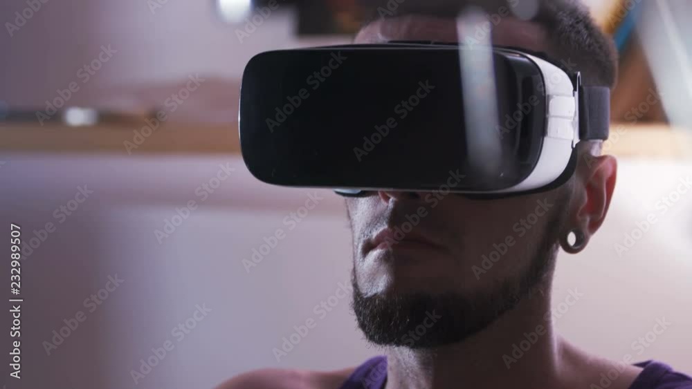Portrait of young man in virtual reality headset. Scientists. Computer graphics, 3D, programming, technology. Virtual reality headset. Close-up. Portrait of young man in virtual reality headset. Scientists. Computer graphics, 3D, programming, technology. Virtual reality headset. Close-up.