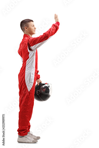 Young racer waving with his hand