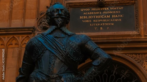 Latin inscription next to Sir Thomas Bodley statue in the Tower of the Five Orders of the Bodleian Library, Oxford, England photo