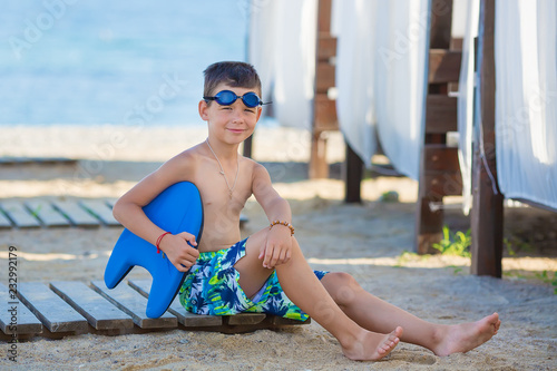 Little boy with snorkel by the sea. Cute little kid wearing mask and flippers for diving at sand tropical beach. Ocean coast.