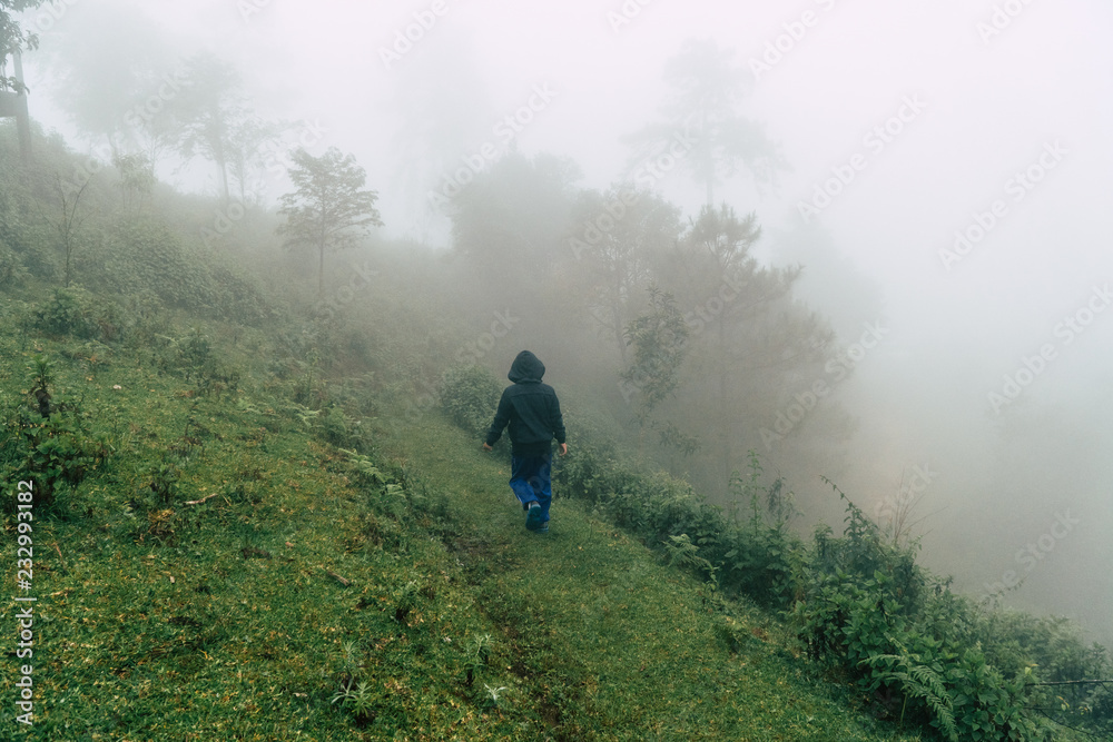 The boy are walking on hill and thick foggy
