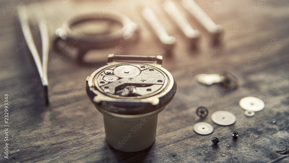 Watchmaker is repairing the mechanical watches in his workshop Watchmaker is repairing the mechanical watches in his workshop