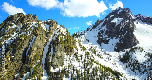 Sawtooth Mountains, Idaho, USA - Jagged Snowy Peaks With Pine Trees On The Slopes