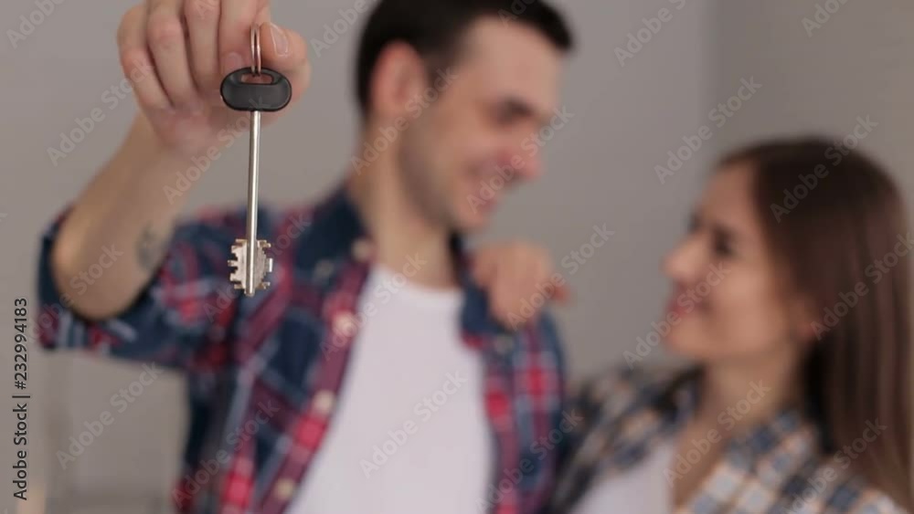Close-up of a loving couple holding the key to their new apartment ...