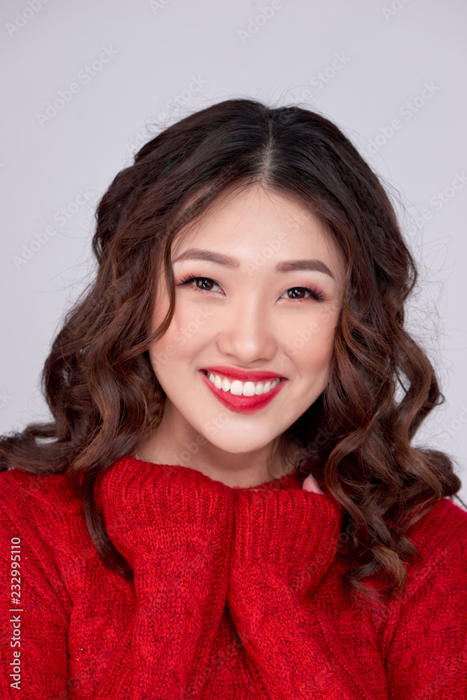 Portrait of beauty winter asian girl in red knitted woolen dress. Christmas Holiday. Portrait of beauty winter asian girl in red knitted woolen dress. Christmas Holiday.