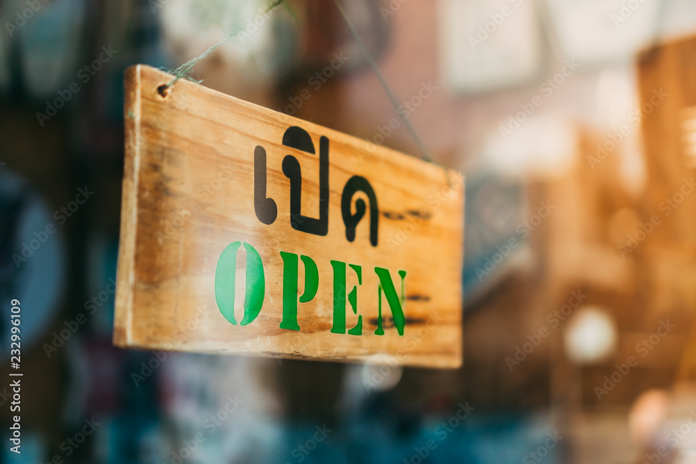 Welcome open sign on door of coffee cafe shop.