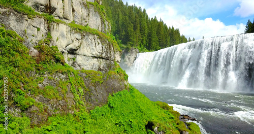 Mesa Falls, Idaho, USA - Wide Waterfalls Surrounded By Green Pine Trees With A Rainbow photo