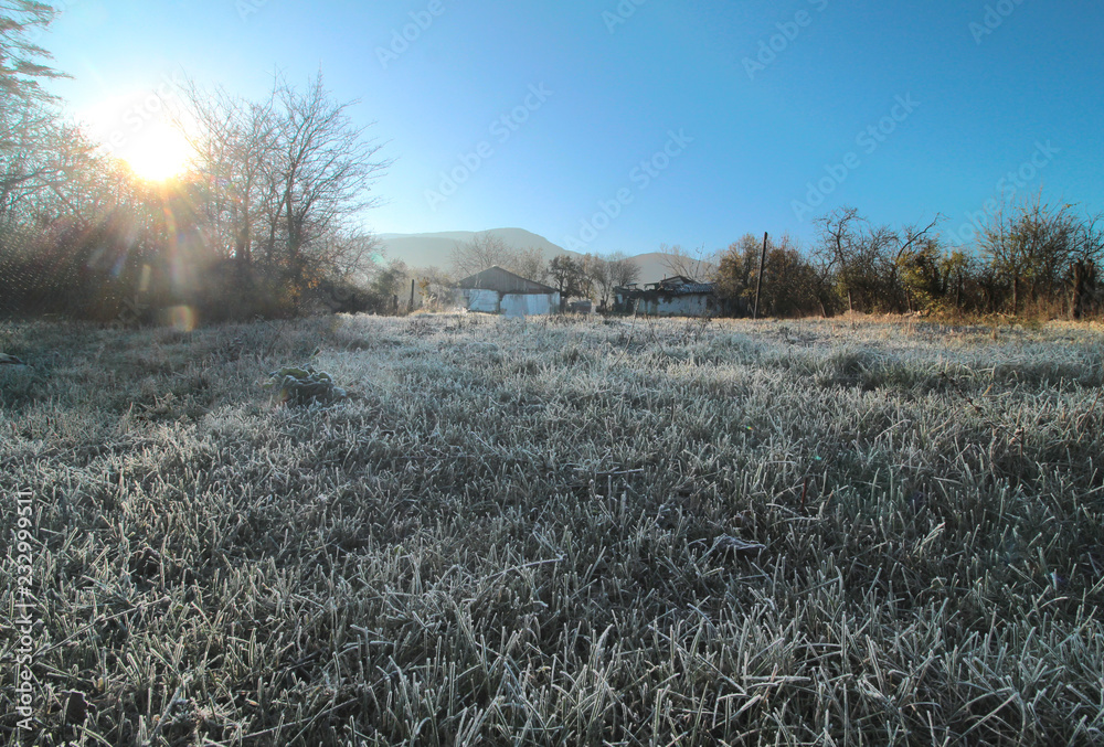 frost on the grass plain in front of the mountains frost on the grass plain in front of the mountains
