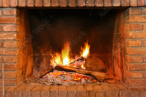 Fireplace with red bricks and fire