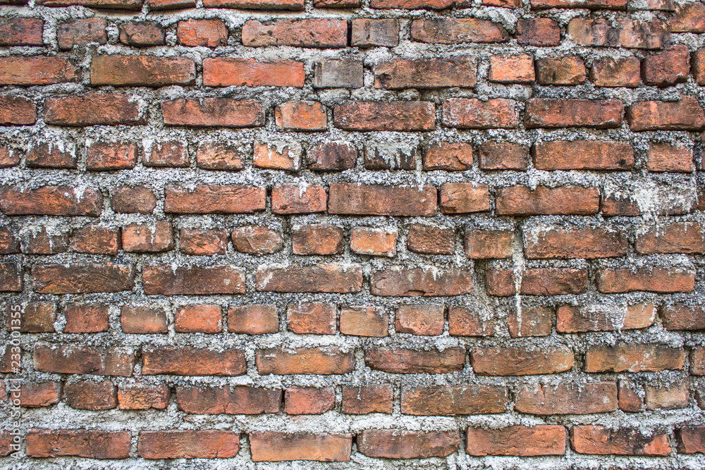 Fototapeta premium old dirty red brick wall with light cement. rough surface texture.