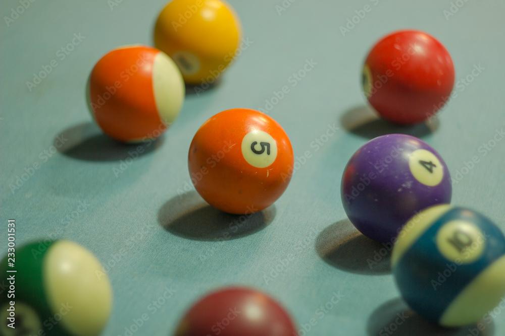 old multi-colored billiard balls with numbers on blue cloth old multi-colored billiard balls with numbers on blue cloth