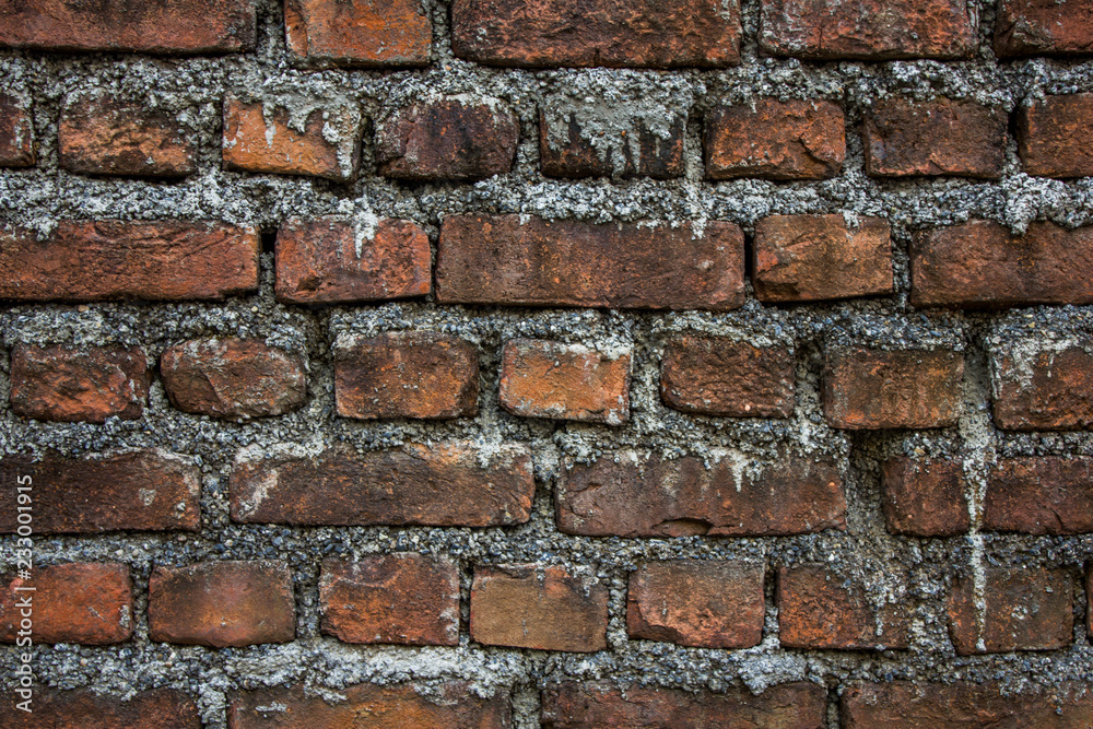 old dirty red brick wall with light cement. rough surface texture. stains of cement on the wall old dirty red brick wall with light cement. rough surface texture. stains of cement on the wall