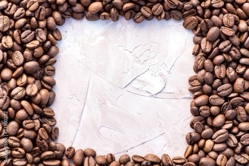 Coffee grains in the bottom of the image on a gently light background © Rudkov