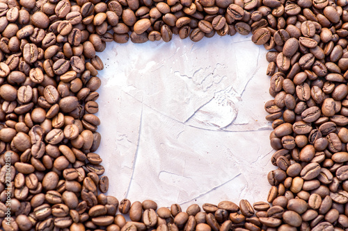 Coffee grains in the bottom of the image on a gently light background © Rudkov