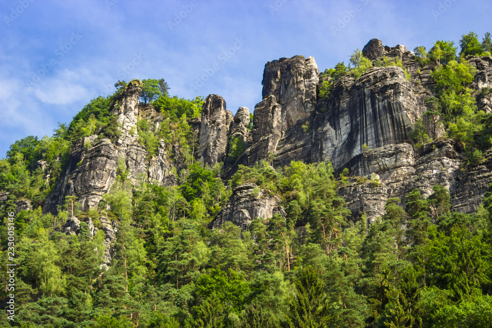 View up on stone formations and the famous Bastei bridge in Saxony, Germany View up on stone formations and the famous Bastei bridge in Saxony, Germany
