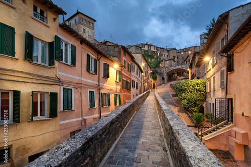 Perugia, Italy. Medieval aqueduct and colorful buildings at dusk