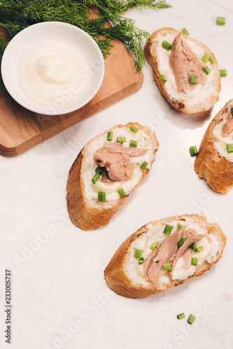 Bruschetta. Sandwich tuna fish salad on wooden background