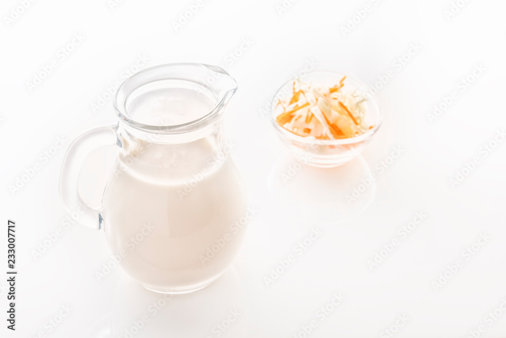 Glass jug with milk on a white background. Close-up. Copy space Glass jug with milk on a white background. Close-up. Copy space