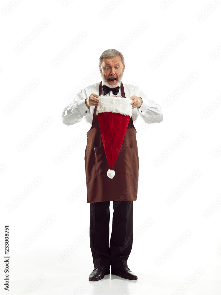 Portrait of Man in Santa Claus Costume - with a Luxurious White Beard, Santa's Hat and a Red Costume at red studio background Portrait of Man in Santa Claus Costume - with a Luxurious White Beard, Santa's Hat and a Red Costume at red studio background