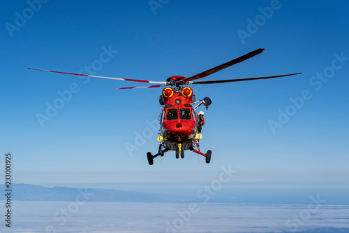 Fototapeta Naklejka Na Ścianę i Meble -  Mountain Rescue Helicopter is called by Altavista Refuge staff to pick up an a hiker who suffers from altitude sickness above 3000m