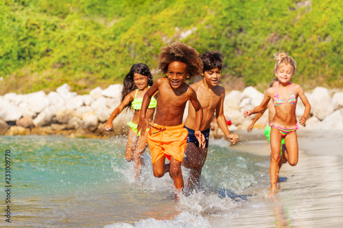 Happy multiethnic kids having fun at the seaside